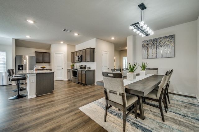 dining room with a textured ceiling and dark wood-type flooring