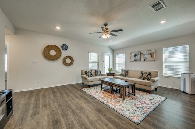 living room with ceiling fan, a textured ceiling, lofted ceiling, and dark wood-type flooring