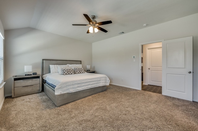 bedroom with vaulted ceiling, ceiling fan, and carpet flooring