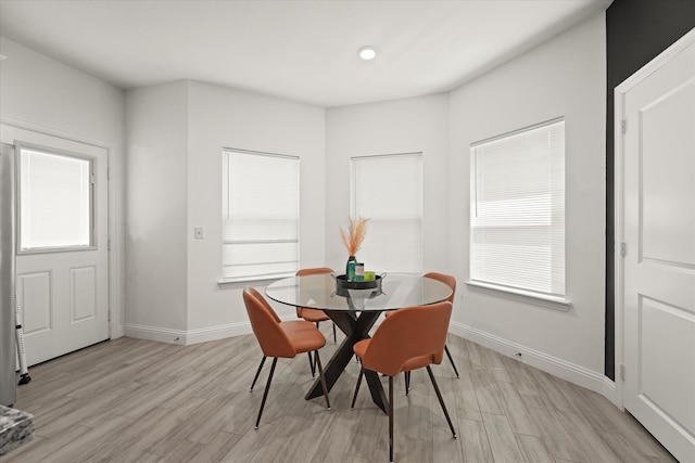 dining area with light hardwood / wood-style floors