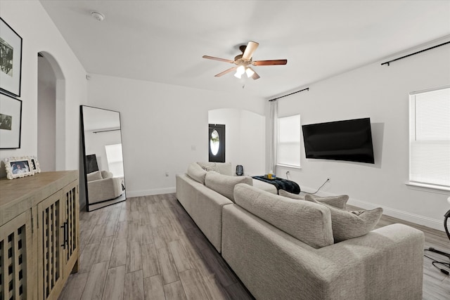 living room featuring light hardwood / wood-style floors and ceiling fan