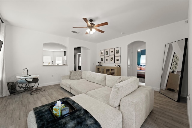 living room with ceiling fan and hardwood / wood-style flooring