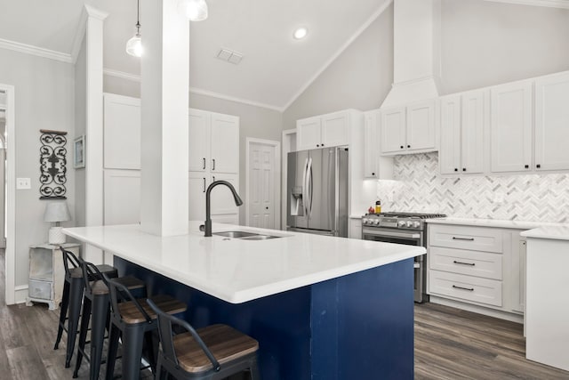 kitchen with white cabinets, hanging light fixtures, sink, a kitchen island with sink, and stainless steel appliances