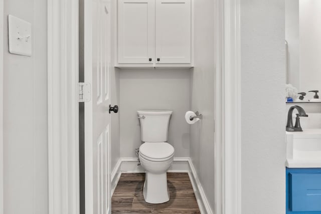 bathroom featuring vanity, hardwood / wood-style floors, and toilet