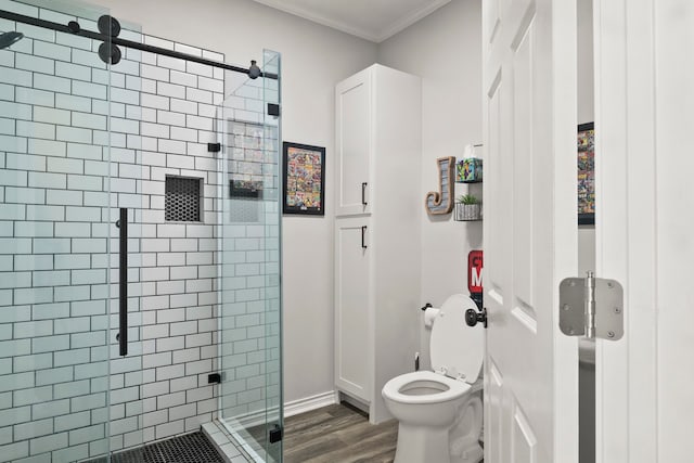 bathroom featuring walk in shower, ornamental molding, hardwood / wood-style floors, and toilet