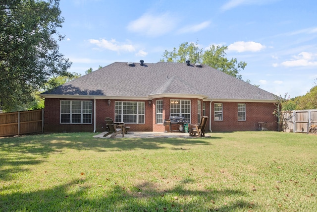 back of house with a lawn and a patio area