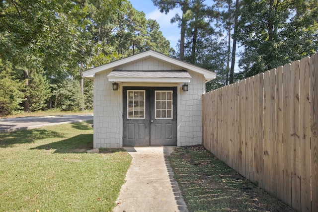 view of outbuilding featuring a yard