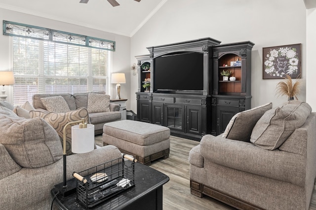 living room with light wood-type flooring, crown molding, ceiling fan, and high vaulted ceiling