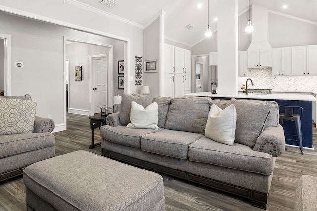 living room with ornamental molding, dark hardwood / wood-style flooring, sink, and high vaulted ceiling