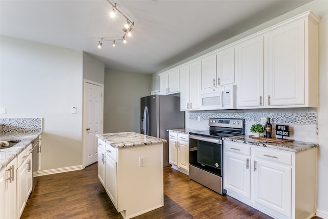 kitchen with a kitchen island, dark hardwood / wood-style flooring, stainless steel appliances, and white cabinets