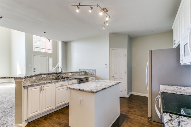 kitchen featuring a kitchen island, sink, dark wood-type flooring, and white cabinets