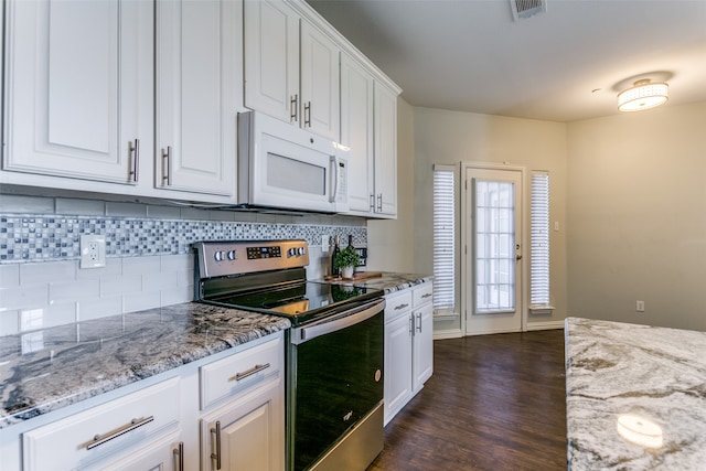 kitchen with electric stove, white cabinets, light stone counters, and dark wood-type flooring