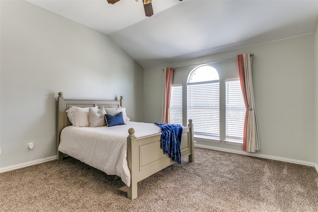 bedroom with vaulted ceiling, ceiling fan, and light colored carpet