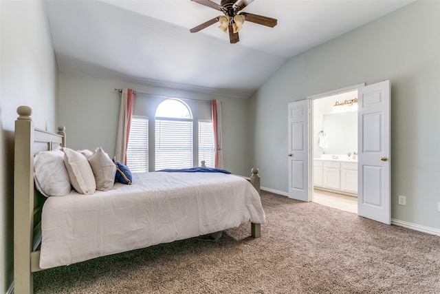 carpeted bedroom with ceiling fan, ensuite bath, and vaulted ceiling