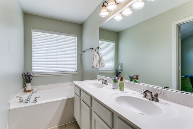 bathroom featuring tile patterned flooring, vanity, and a washtub