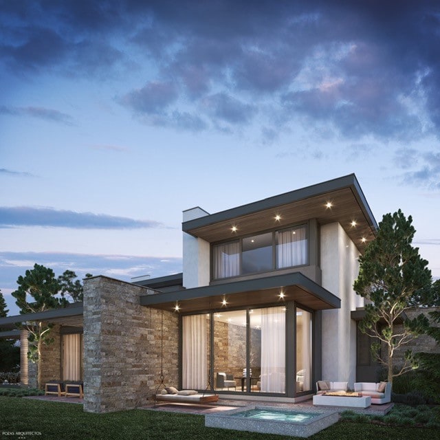 back house at dusk featuring a patio and an outdoor living space