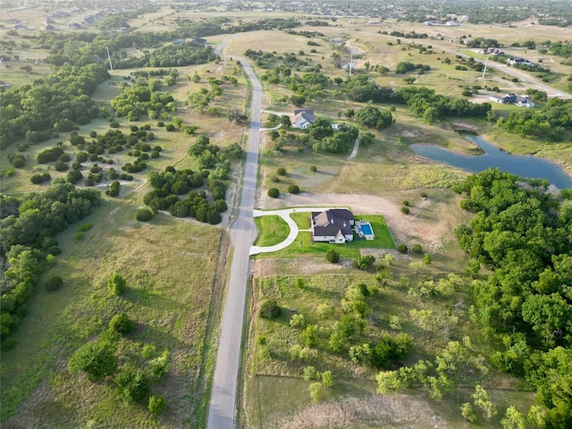 birds eye view of property with a water view and a rural view