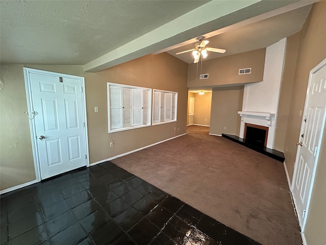 unfurnished living room with lofted ceiling, dark colored carpet, ceiling fan, and a textured ceiling