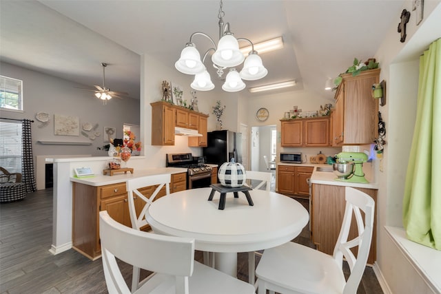 dining space featuring ceiling fan with notable chandelier and dark hardwood / wood-style floors