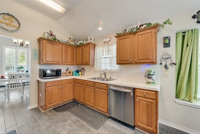 kitchen with vaulted ceiling, stainless steel appliances, hardwood / wood-style floors, sink, and a notable chandelier