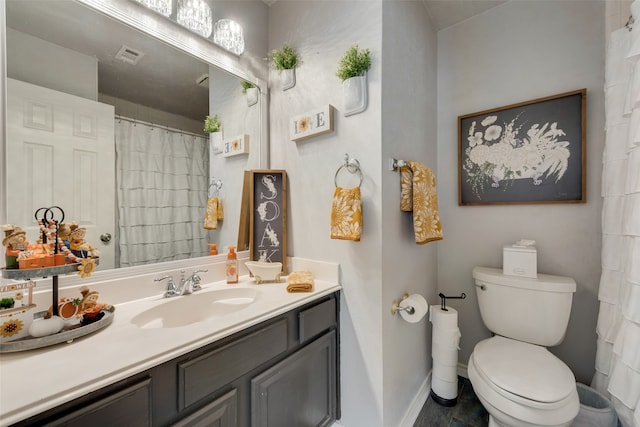 bathroom with vanity, tile patterned flooring, and toilet