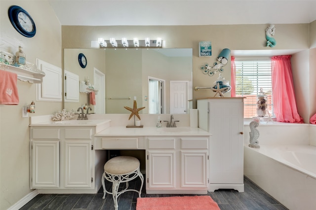 bathroom with wood-type flooring, vanity, and a tub to relax in