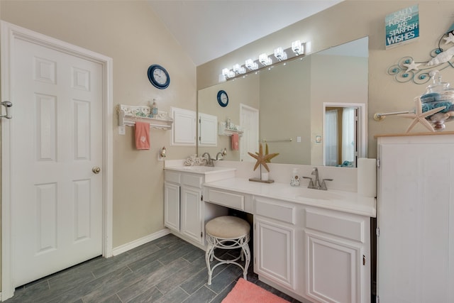 bathroom featuring vanity, lofted ceiling, and hardwood / wood-style floors