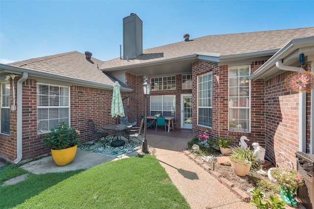 exterior space featuring a patio and a lawn