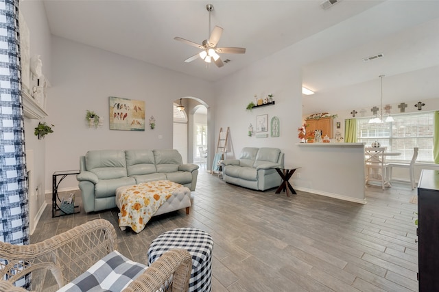 living room featuring ceiling fan with notable chandelier and hardwood / wood-style floors