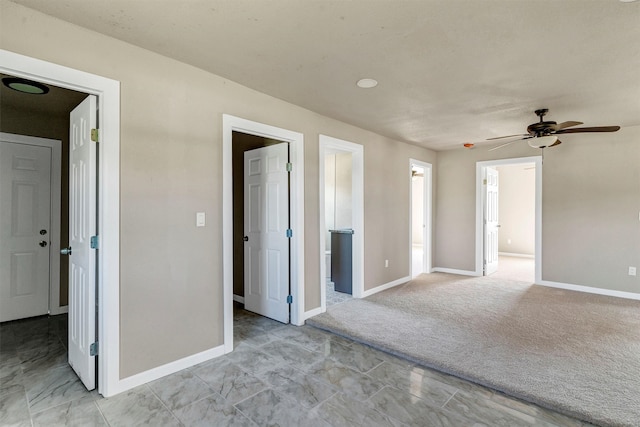 unfurnished room featuring ceiling fan and light colored carpet