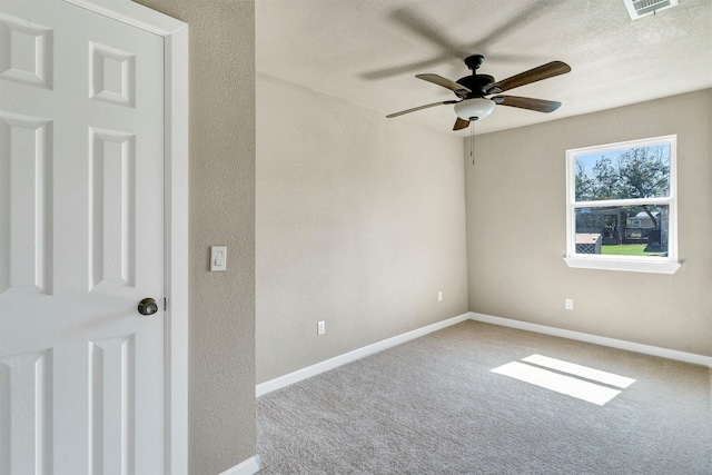 carpeted empty room featuring a textured ceiling and ceiling fan