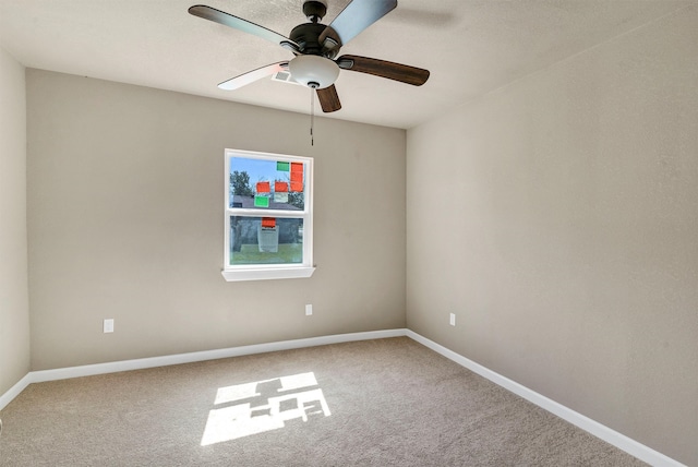 spare room with carpet and ceiling fan