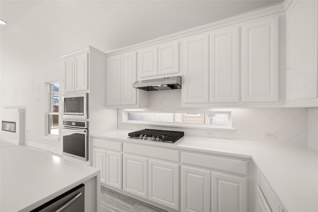 kitchen featuring white cabinetry, appliances with stainless steel finishes, and backsplash