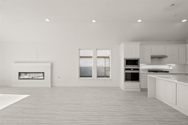 kitchen with tasteful backsplash, stainless steel appliances, and white cabinets