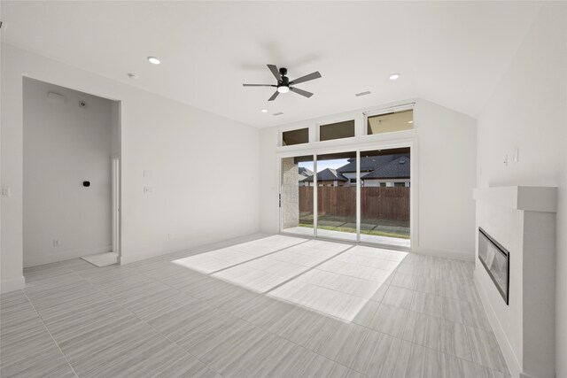 unfurnished living room with lofted ceiling, light tile patterned floors, and ceiling fan