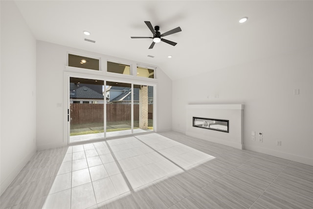 unfurnished living room with ceiling fan, lofted ceiling, and light tile patterned floors