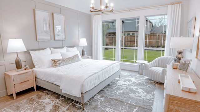 bedroom featuring an inviting chandelier and hardwood / wood-style floors