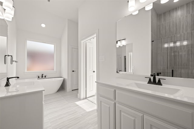 bathroom featuring vanity, separate shower and tub, and vaulted ceiling