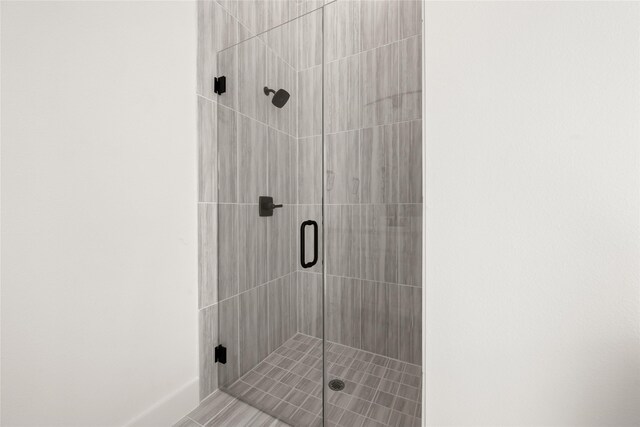 bathroom with a shower with shower door