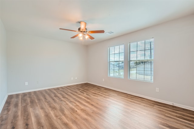 empty room featuring wood-type flooring and ceiling fan