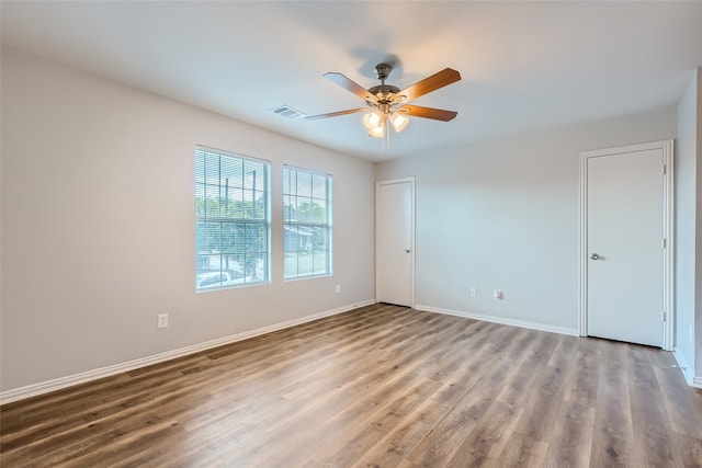 unfurnished room featuring ceiling fan and hardwood / wood-style flooring