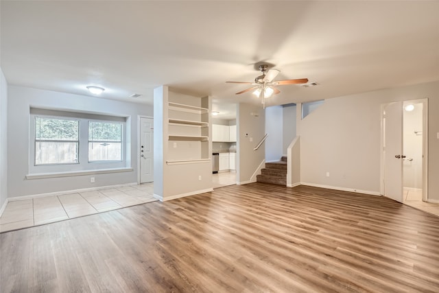 unfurnished living room featuring light hardwood / wood-style floors and ceiling fan