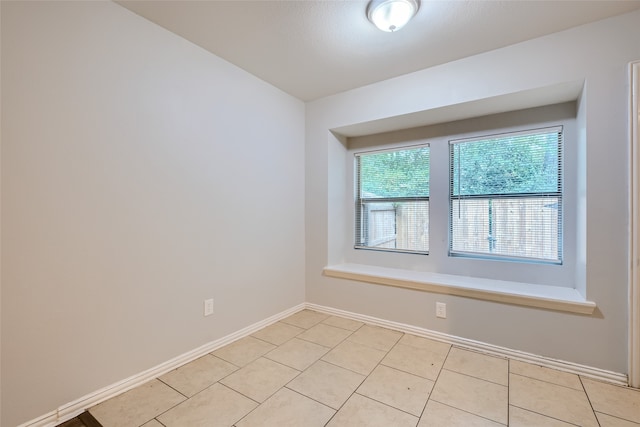 empty room with light tile patterned floors