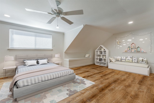 bedroom with ceiling fan, crown molding, vaulted ceiling, and wood-type flooring