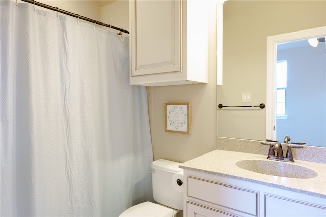 bathroom with vanity, toilet, and a shower with shower curtain