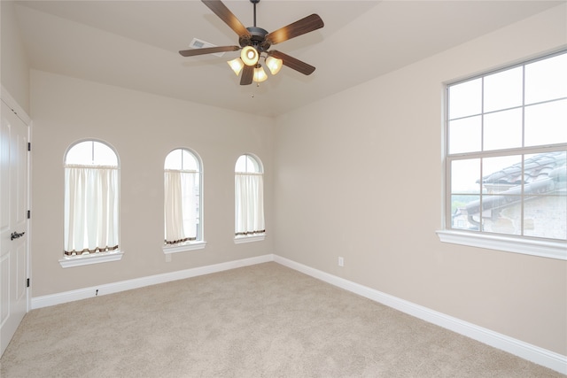 spare room with light carpet and ceiling fan