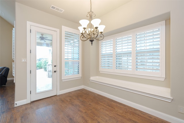 doorway to outside featuring a chandelier and dark hardwood / wood-style floors