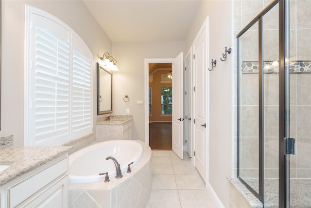 bathroom featuring vanity, plus walk in shower, and tile patterned floors