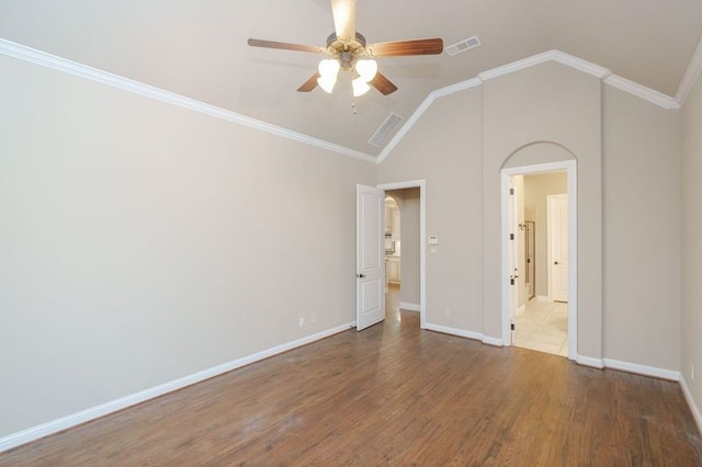 unfurnished bedroom with ornamental molding, lofted ceiling, ceiling fan, and hardwood / wood-style flooring