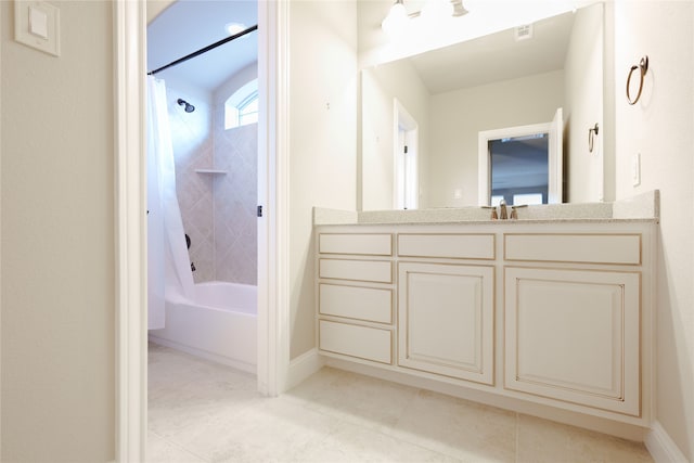 bathroom with shower / bath combo with shower curtain, tile patterned flooring, and vanity